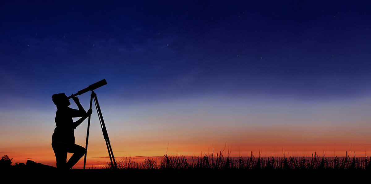 Person looking through a telescope